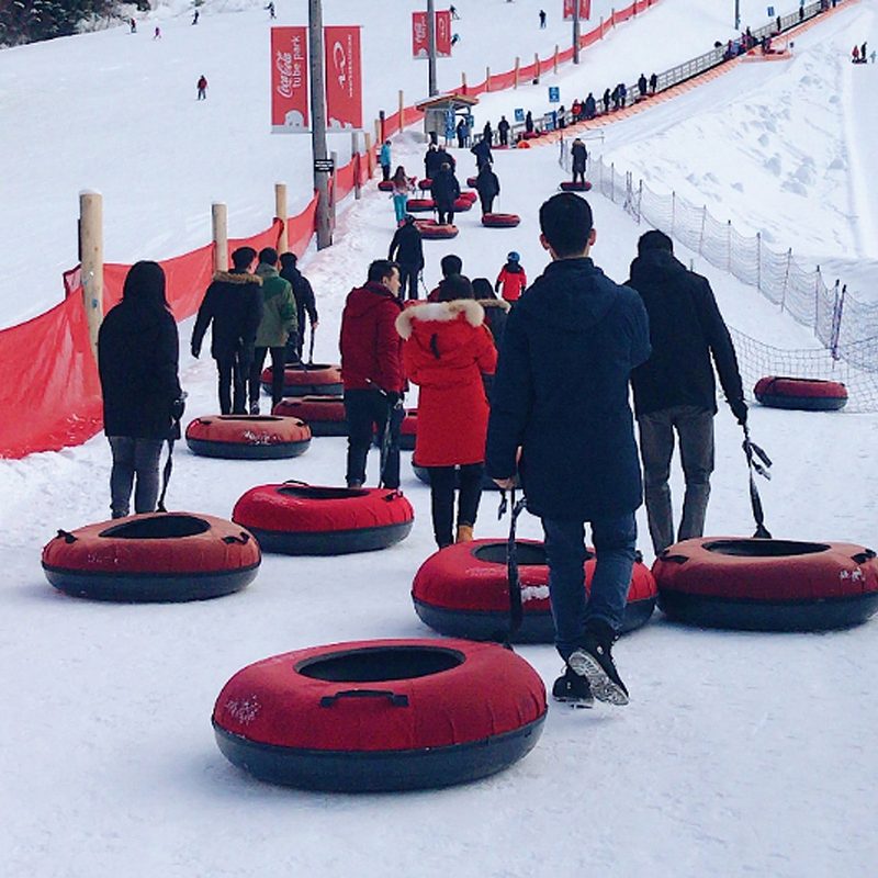 A group of people snow tubing.