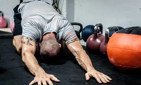 Man doing child's pose stretch