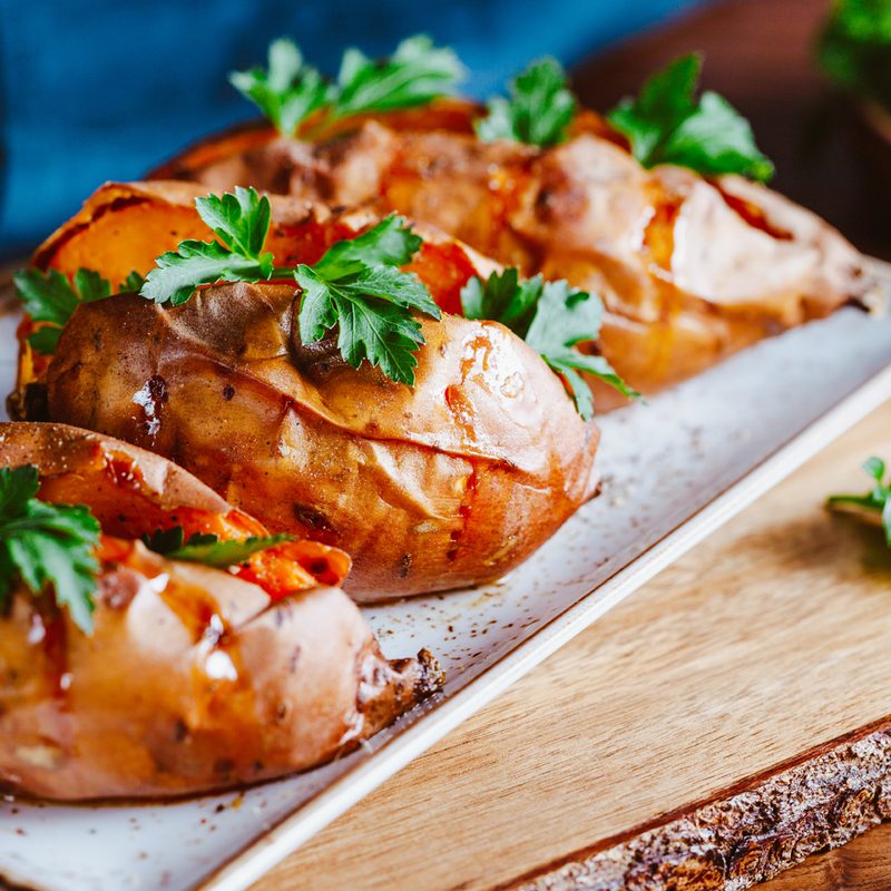 Three sweet potato boats served on a white dish.