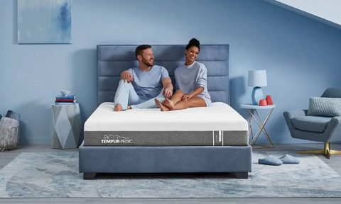 Tempur-Cloud with couple sitting on the bed.