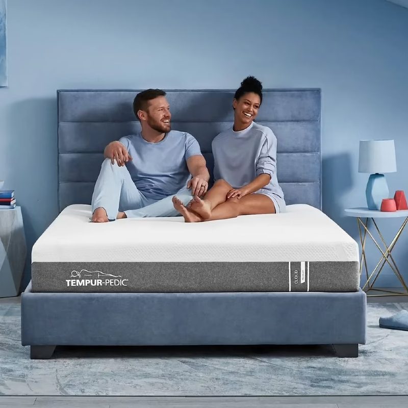 Tempur-Cloud mattress with couple sitting on the bed.