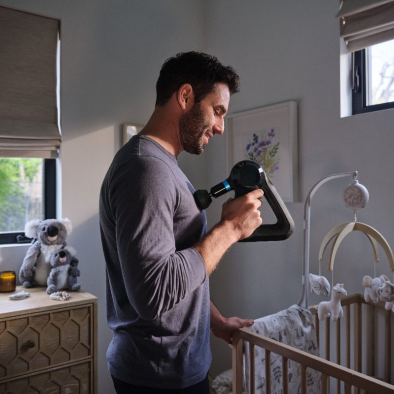 Theragun Elite massage device used by new Dad in nursery!