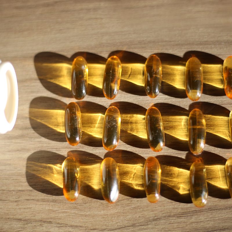 Vitamin D capsules arranged neatly on a table.