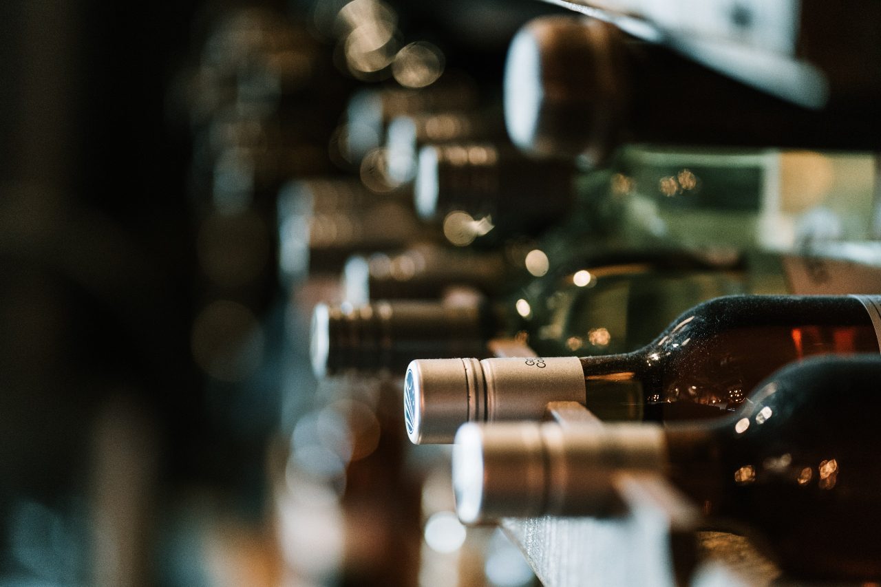 Wine bottles on a shelf.
