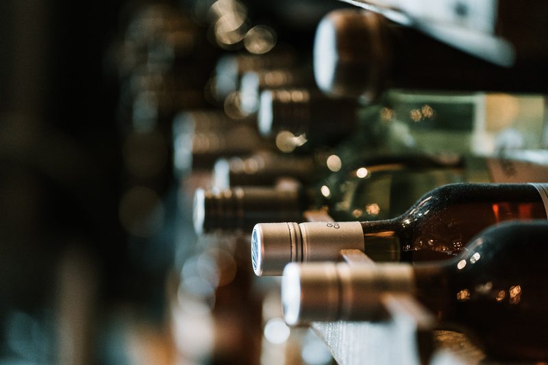 Wine bottles on a shelf.