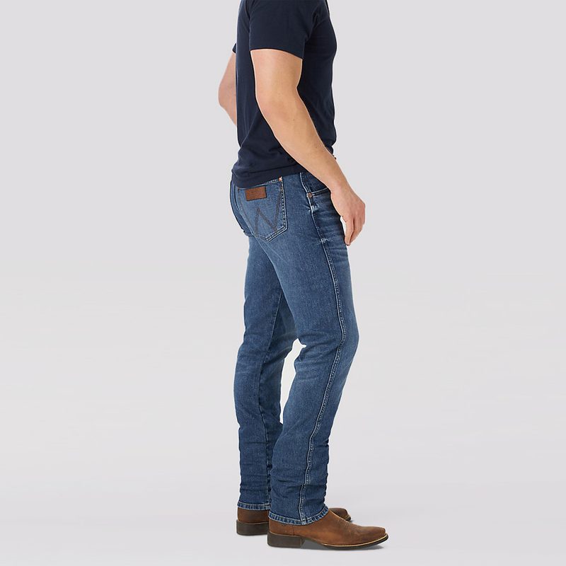 A side profile of man's body wearing a pair of Wrangler Retro Green Slim-Straight Jeans.
