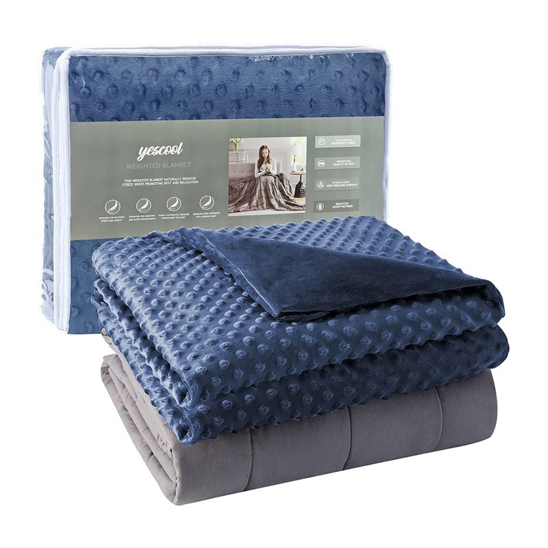 A folded Yescool Weighted Blanket with Removable Cover with its packaging behind it.