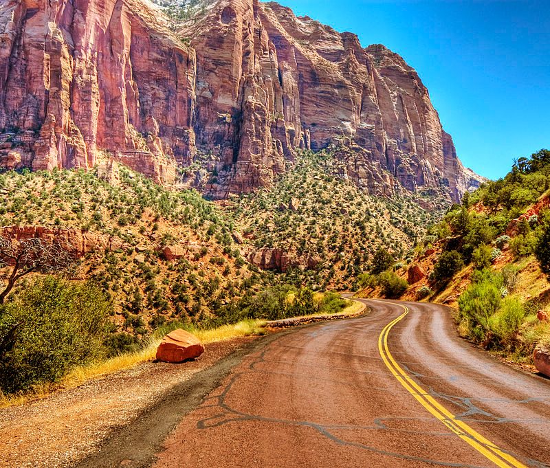 windy road going through the mountainous Zion National Park.