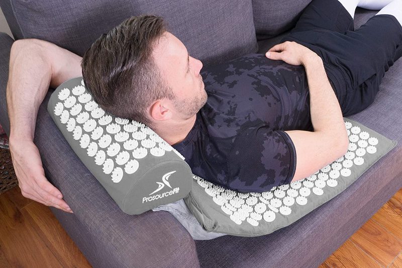 man laying on an Acupressure mat.