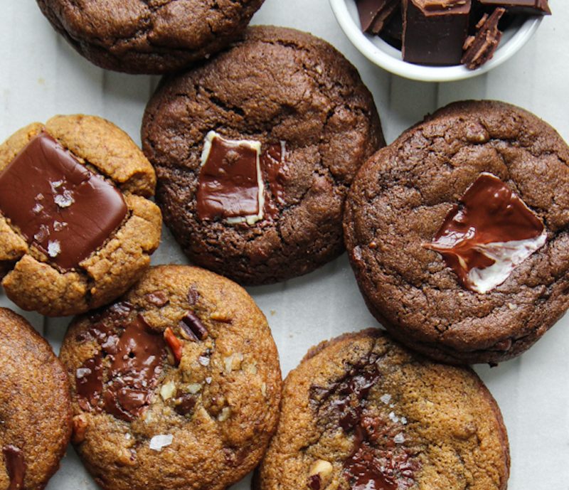 Alter Eco Chocolate cookies with a cup of chopped chocolate pieces.