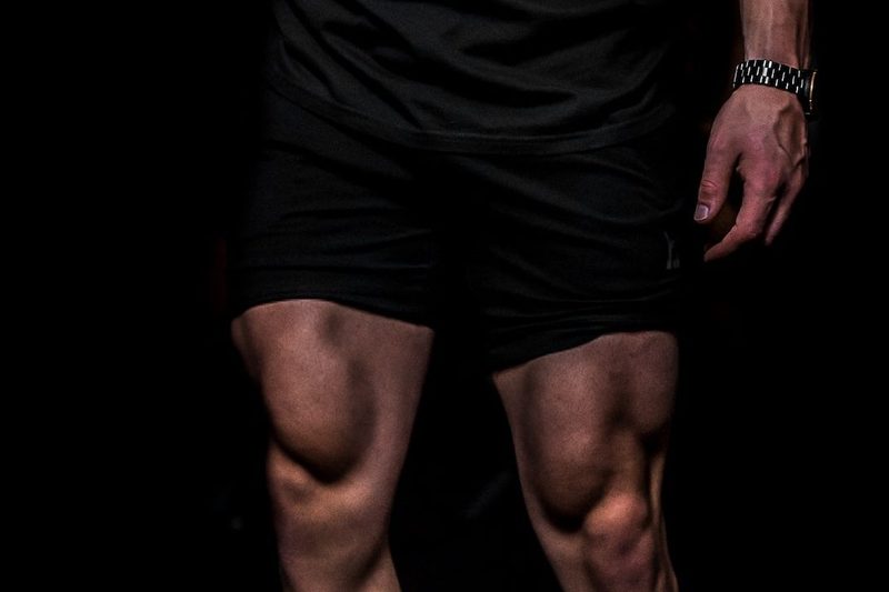 A close-up of a male athlete's quad muscles.
