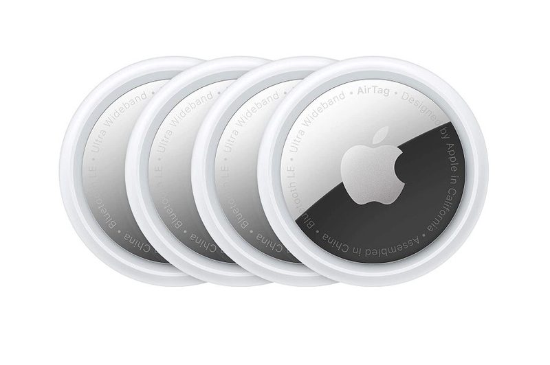 Four Apple Airtags on a white background.