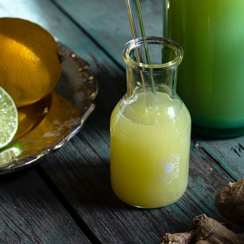 Lemons and limes on a dish next to lemon-lime juice cleans