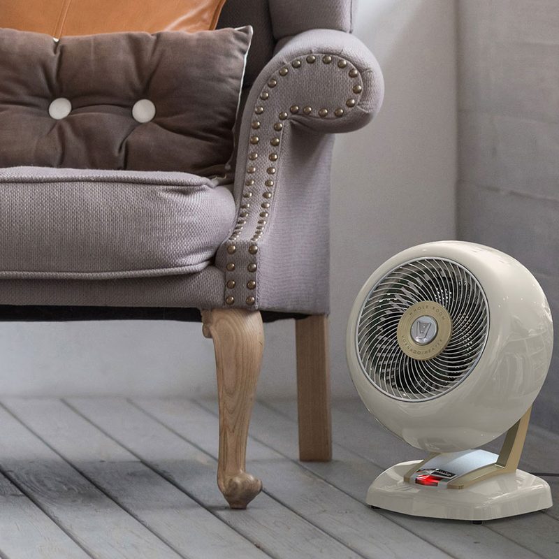 A space heater beside an armchair in a living room.