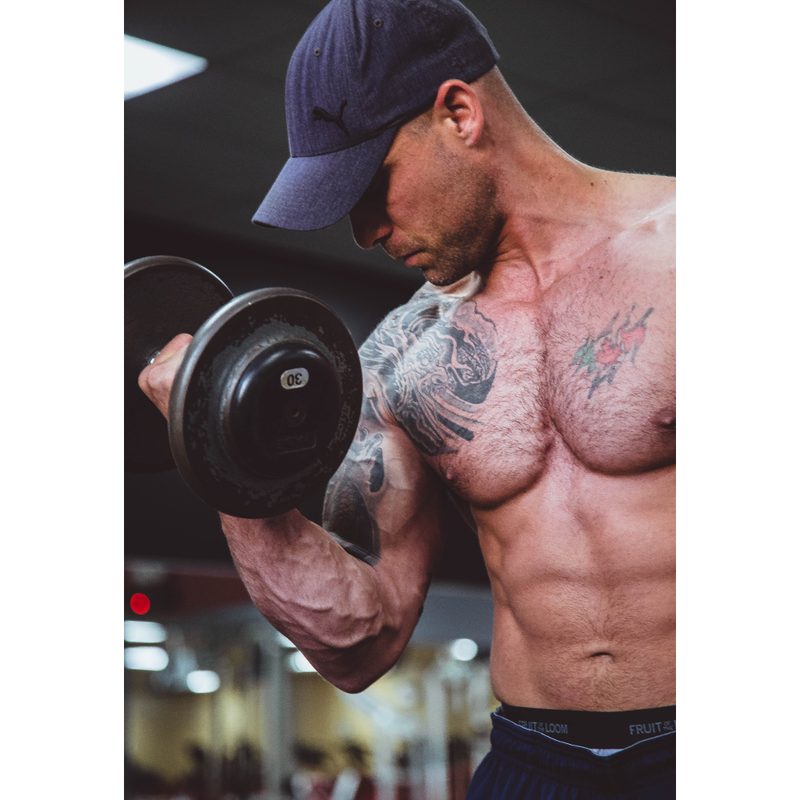 Man in a baseball cap doing Bicep Curls.