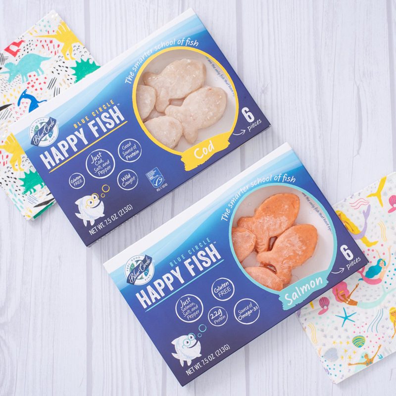 A bird's eye view of two boxes of Blue Circle Happy Fish on a table.
