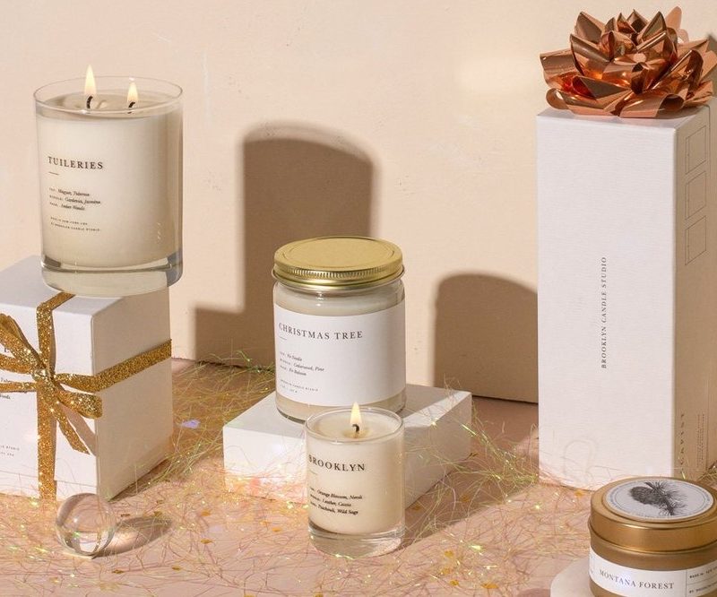 Brooklyn Candle Studio candles shown in and out of their boxes on display.