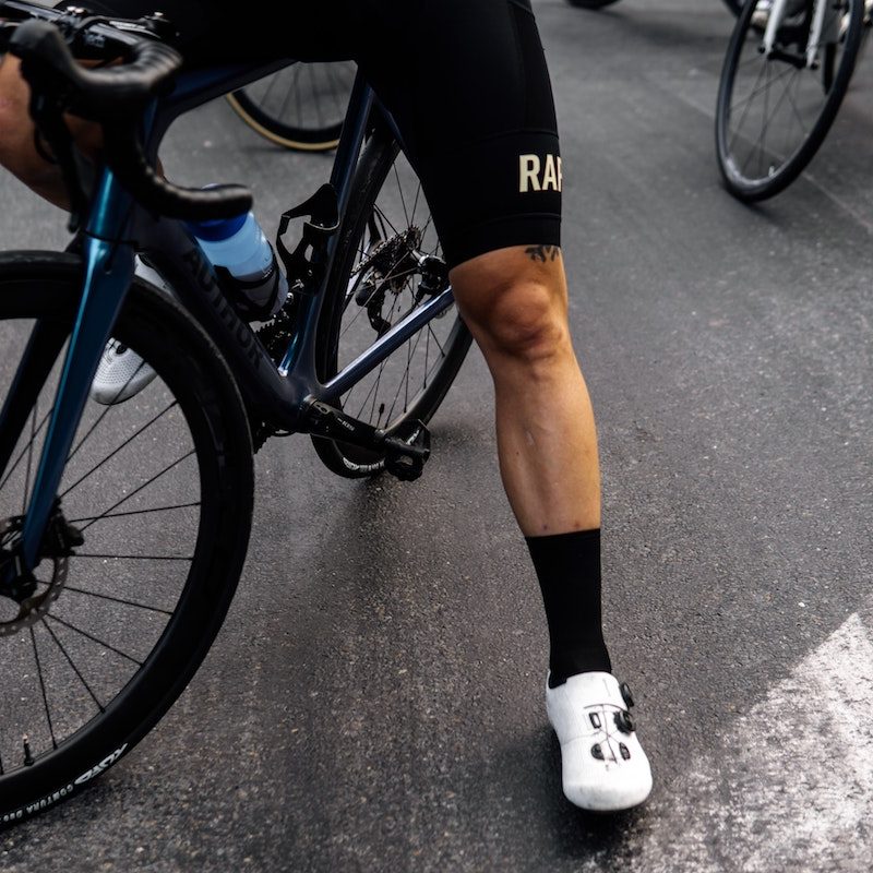 Strong quads with man by bike.
