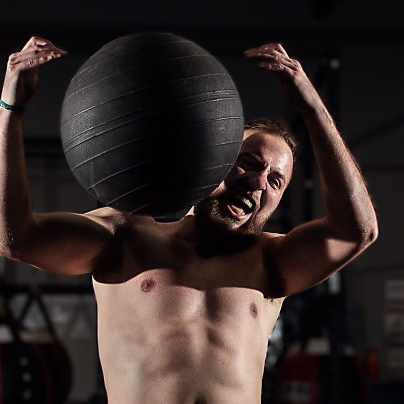 man catching medicine ball.