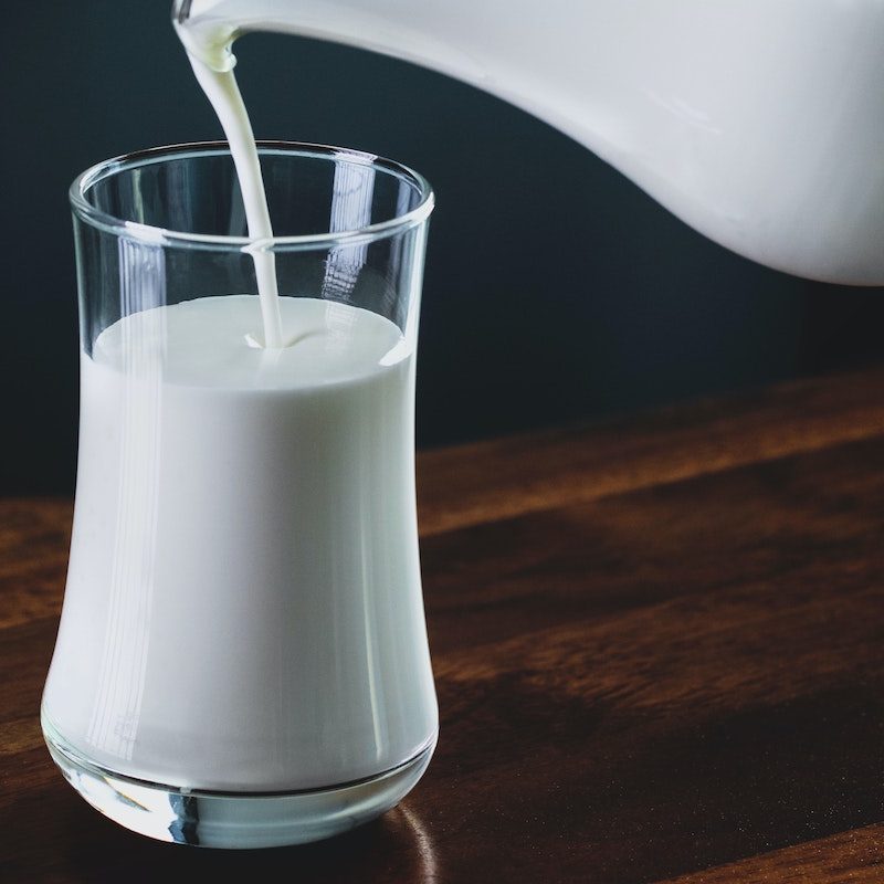Glass of milk being poured.