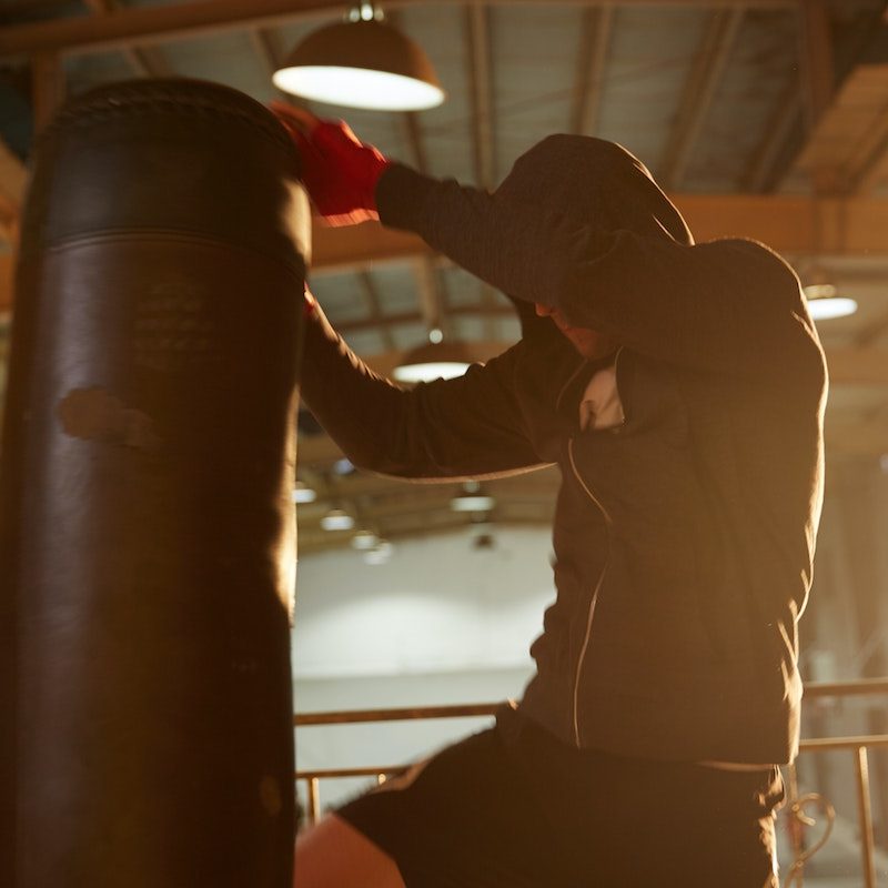 Man kneeing a punching bag