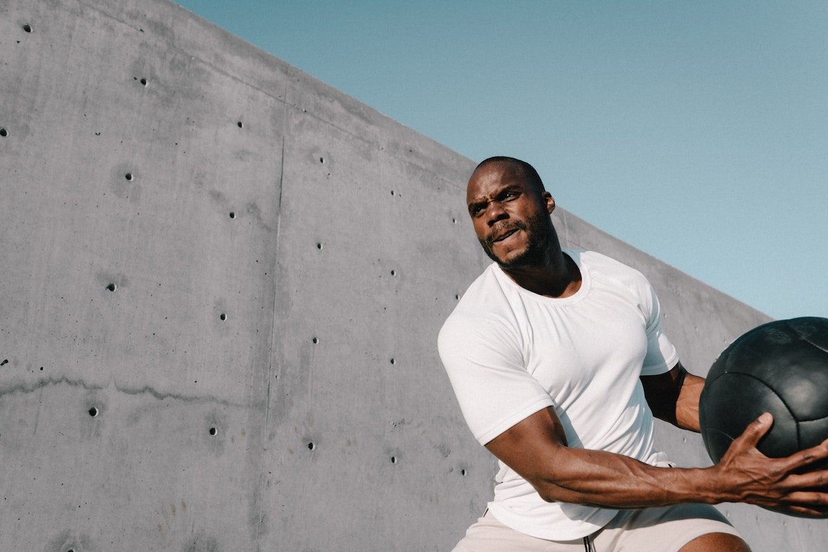 Man doing medicine ball slams.