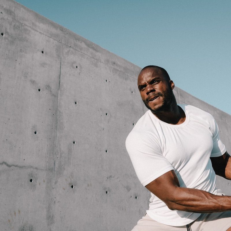 Man doing medicine ball slams.