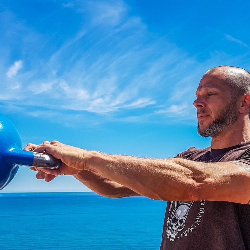Man doing kettlebell swings