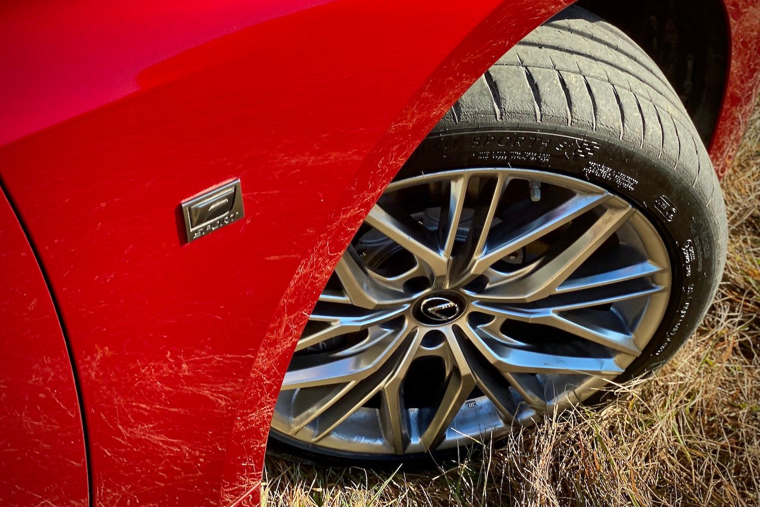 Close up of Lexus IS 500 front passenger's side tire from above.