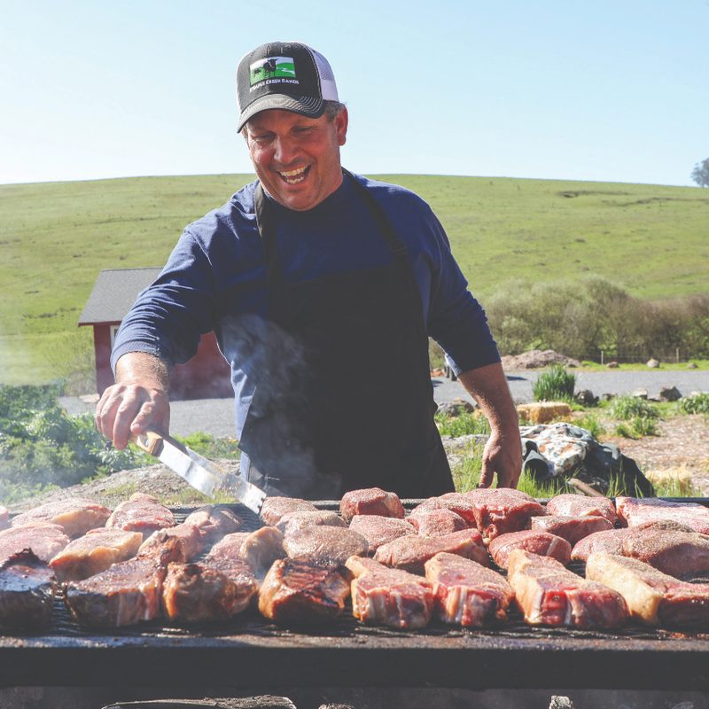 Loren Ponica of Stemple Creek cooking on a grill.
