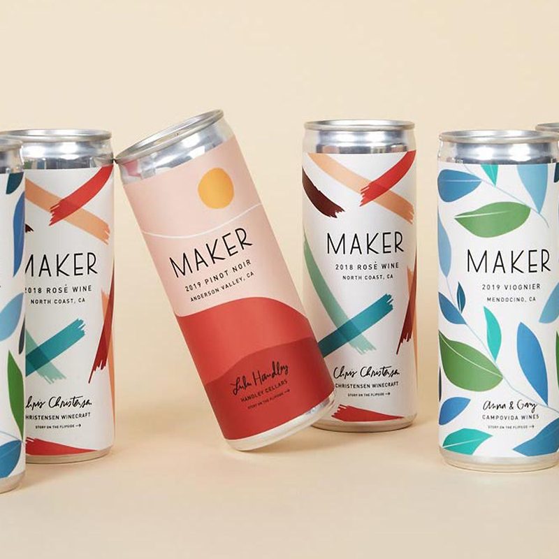 Six cans of beverages displayed on flesh-colored background.