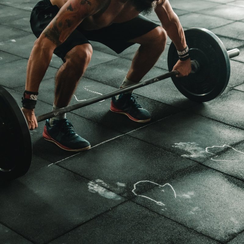 Man deadlifting alone.