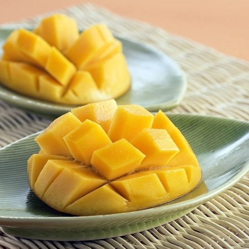 Mango cut open on plates