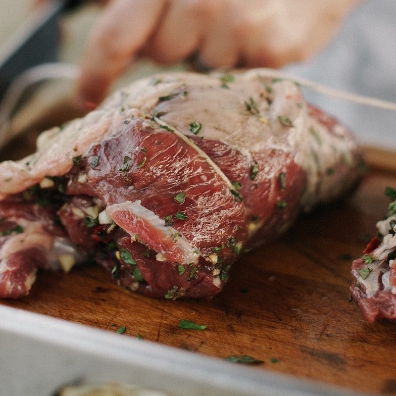 fatty red meat on a cutting board.