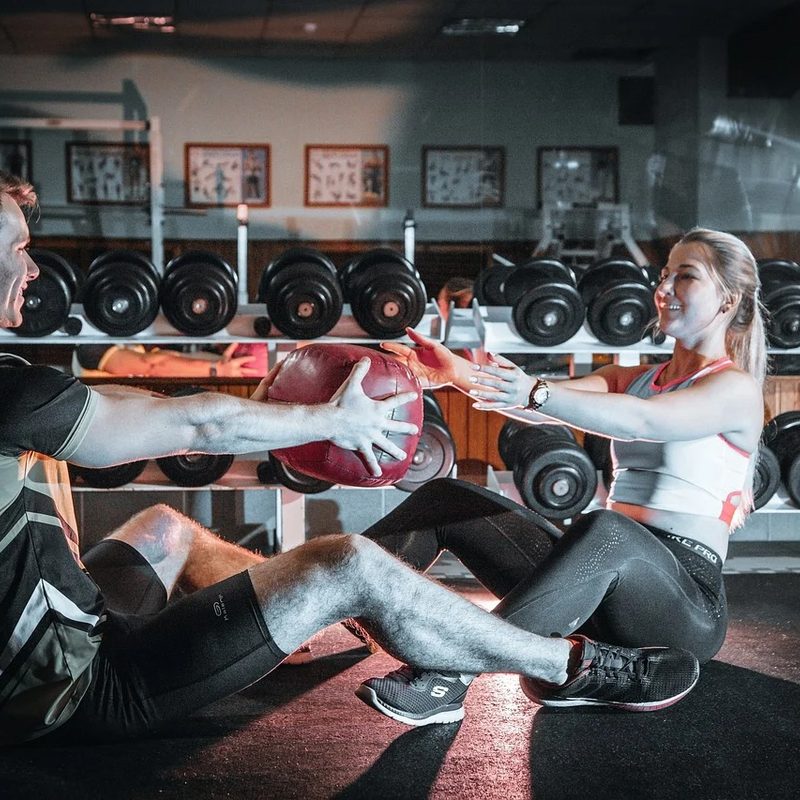 Couple doing medicine ball workout together.