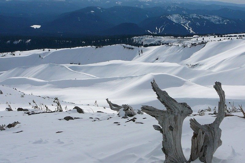 snow drifts with mountains in the background.
