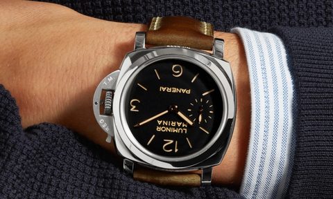 A close-up of a man's hand wearing a Panerai Luminor Marina.