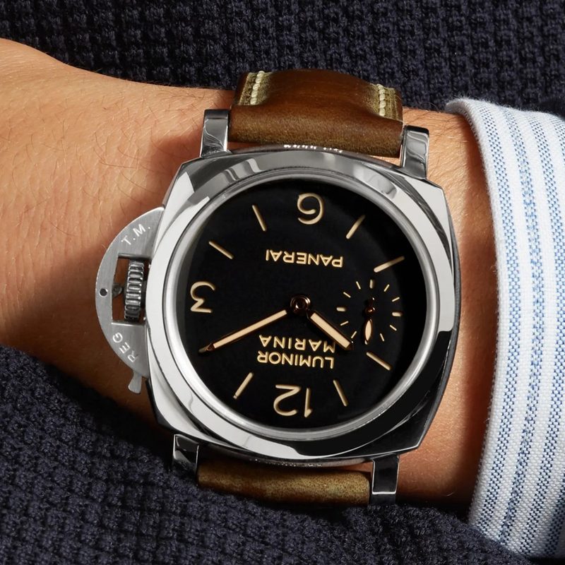 A close-up of a man's hand wearing a Panerai Luminor Marina.