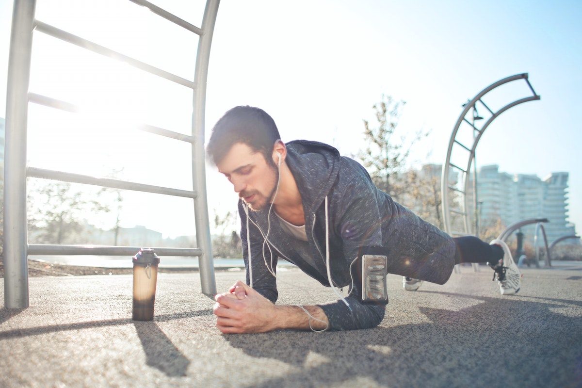 Man doing plank outside