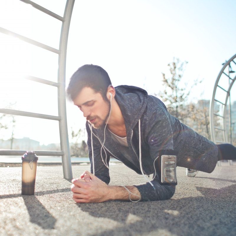 Man doing plank with pre-workout supplement