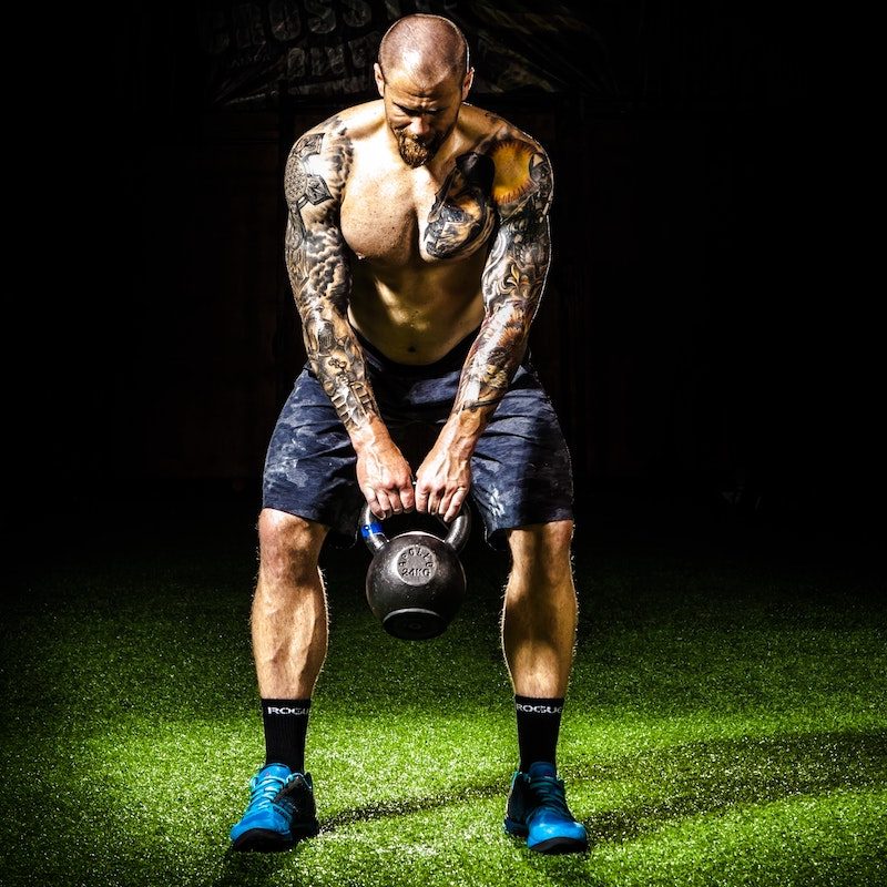 Man doing kettlebell swings