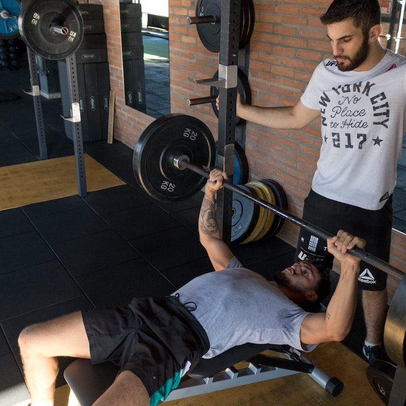 lifting weights with spotter.