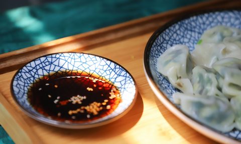 Soy sauce next to a plate of food