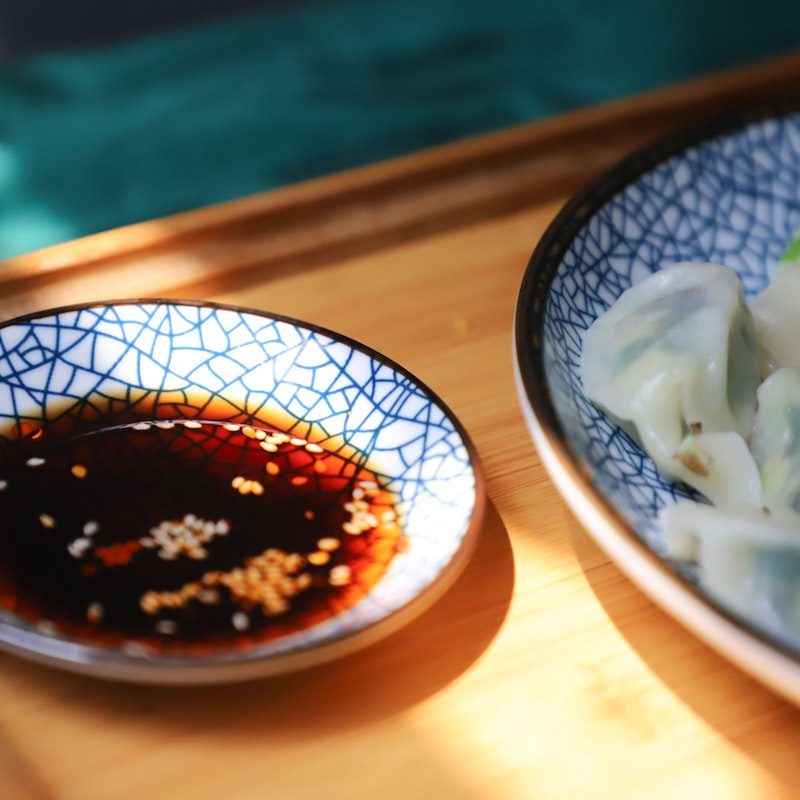 Soy sauce next to a plate of food