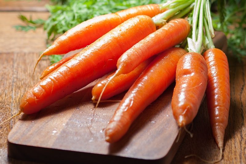 Raw carrots on a cutting board