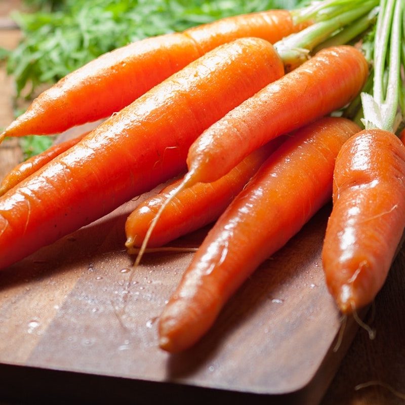 Raw carrots on a cutting board