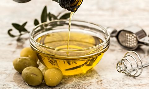 Olive oil being poured into a bowl.