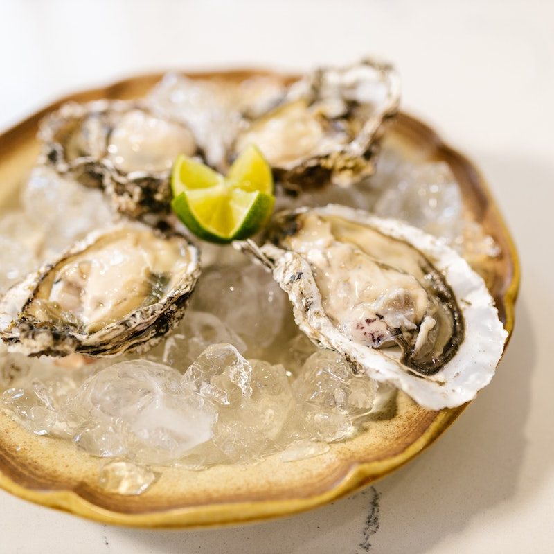 oysters on the half shell sitting on ice.