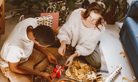 woman giving man a gift.