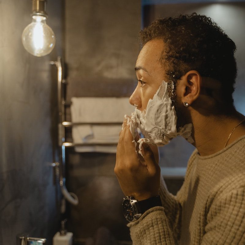 Man shaving in the mirror
